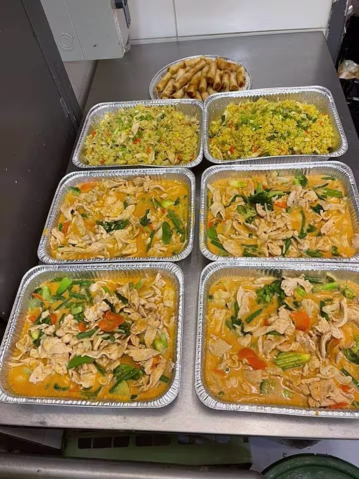 Foil trays of Thai curry ready for catering