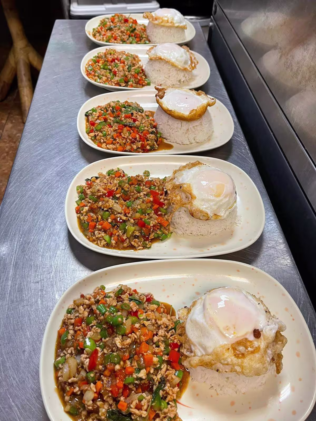 Plated Thai rice dishes topped with fried egg